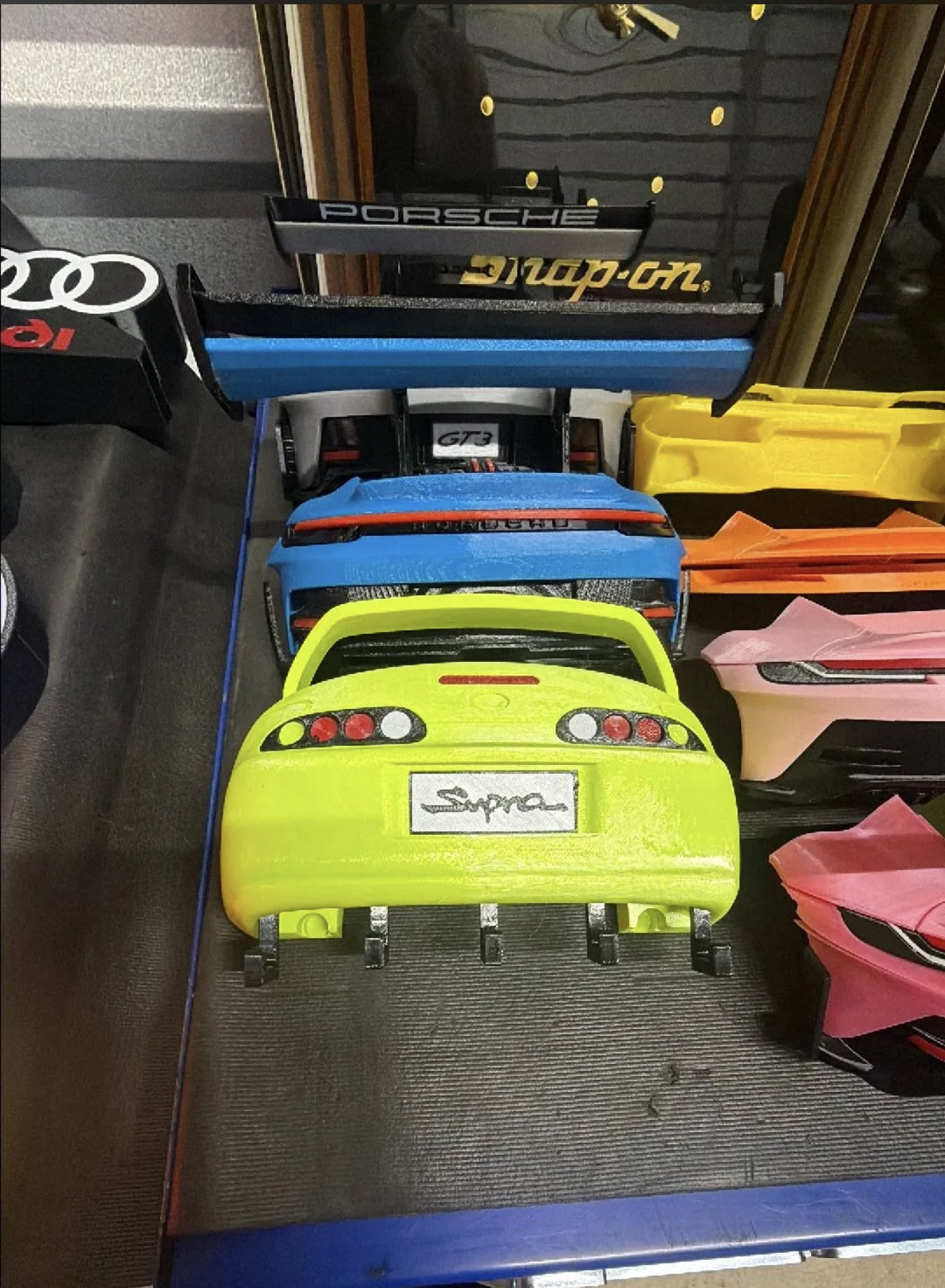 Custom 3D printed car display with multiple colorful car-body parts.