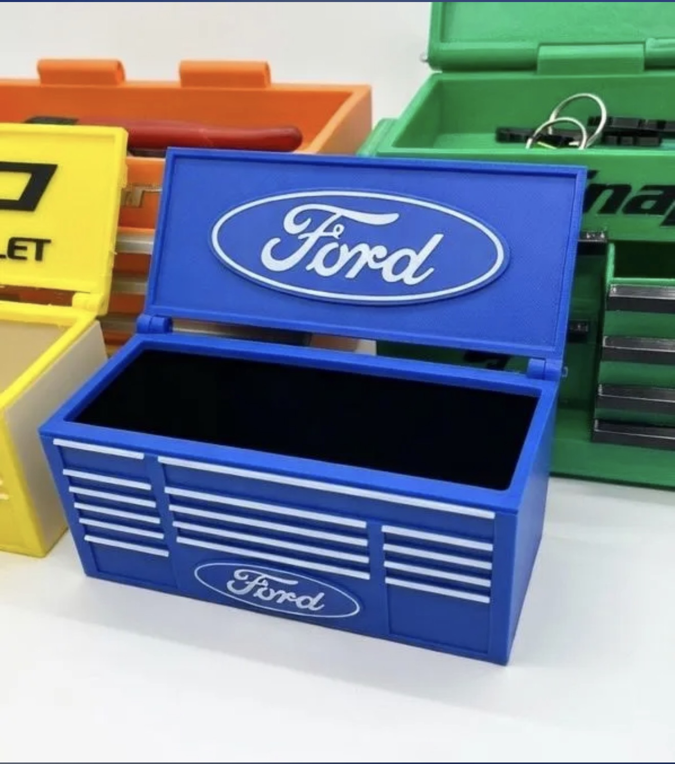 Custom 3D printed mini tool box in blue with white logo-style detail.