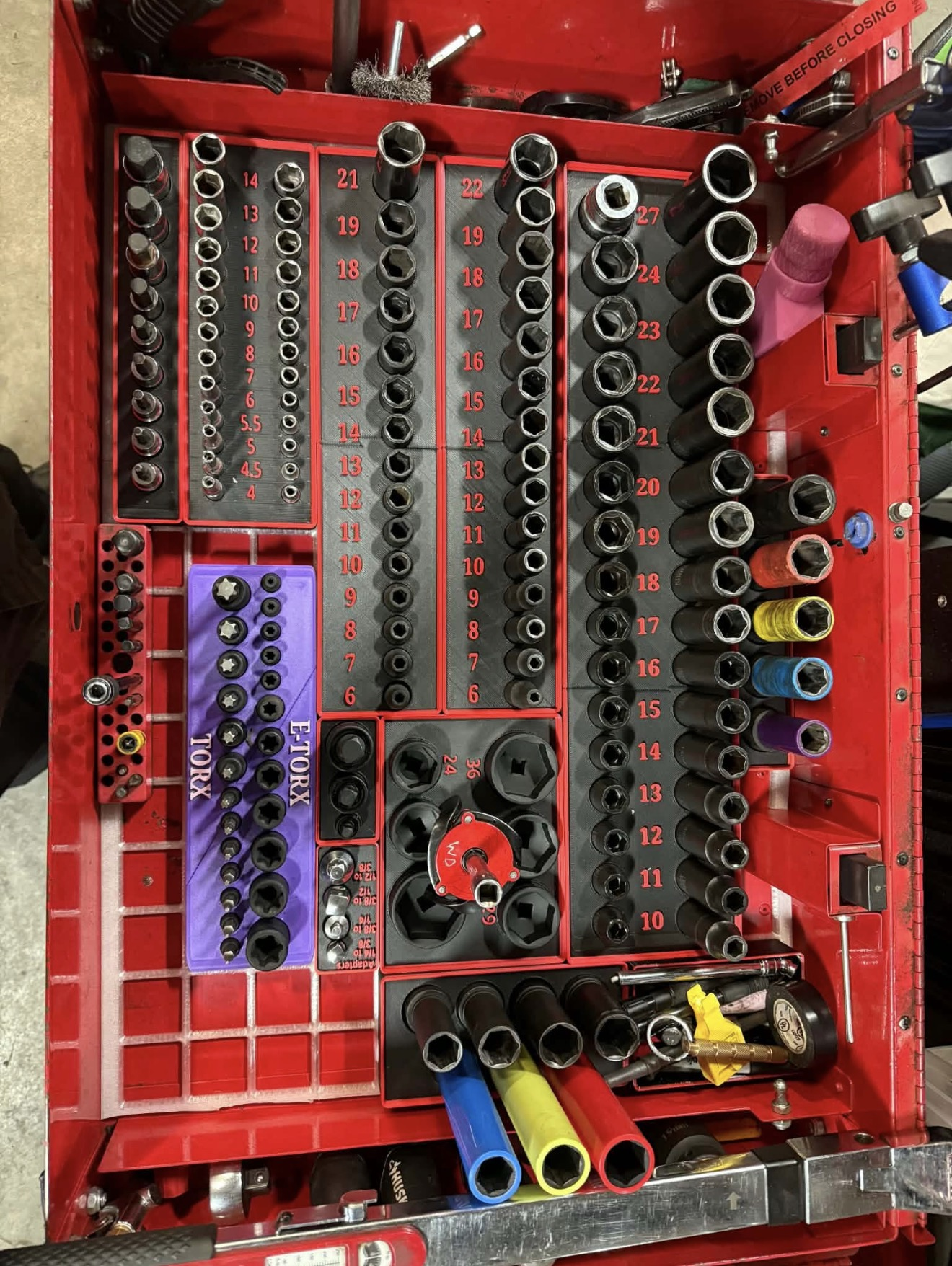 Red tool drawer organized with custom Gridfinity-style socket holders and labeled trays.